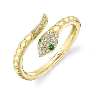 A yellow gold snake shape ring with tsavorite garnet eyes and diamonds set in the head and tail