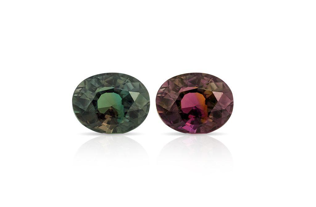 Two alexandrite stones next to each other on an isolated white background